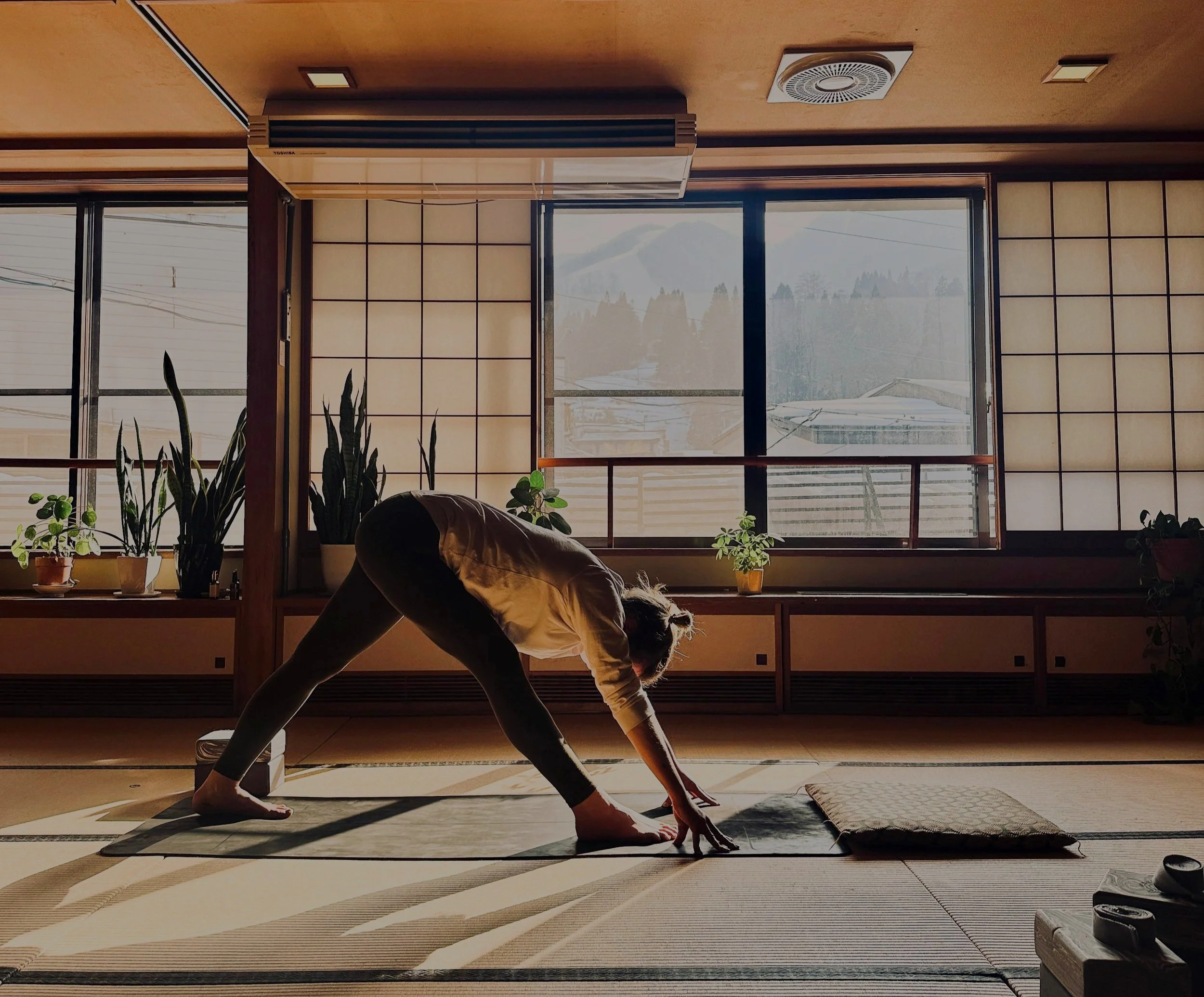 Yoga participant practicing calm diaphragmatic breathing in a peaceful studio setting